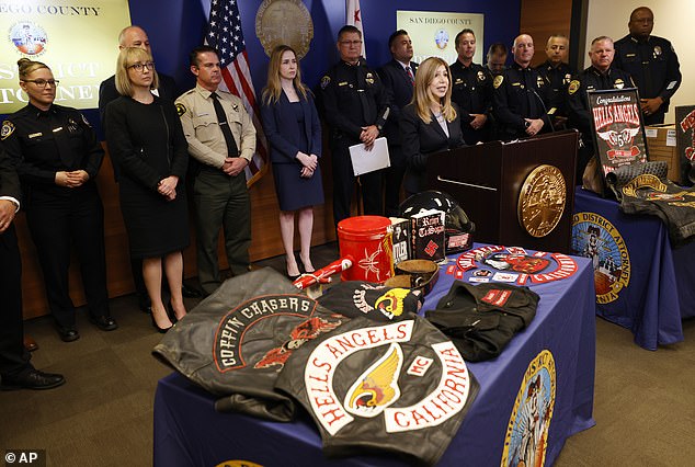 In June, seventeen members and supporters of the Hells Angels motorcycle gang were arrested in connection with a racially motivated attack in San Diego.  Pictured: San Diego County District Attorney Summer Stephan presents Hells Angels paraphernalia during a press conference on Monday