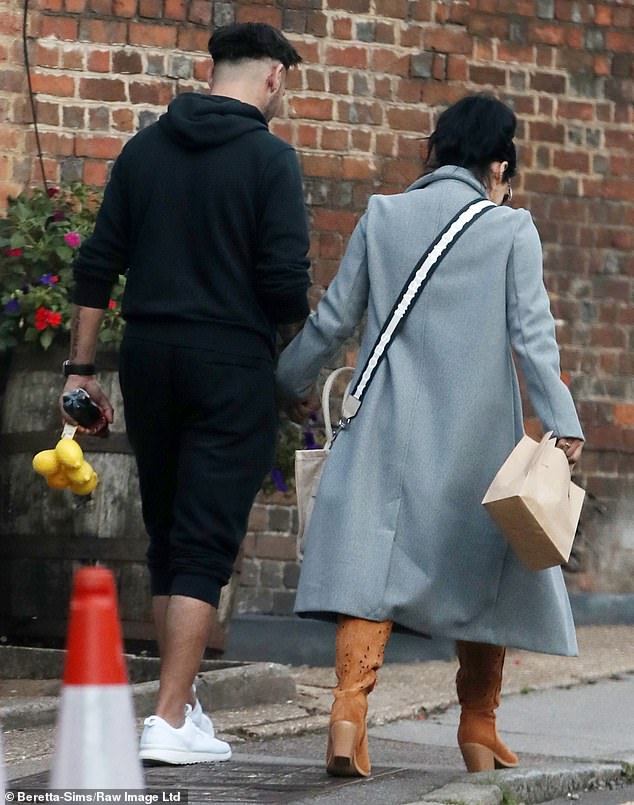 Holding hands: The new couple packed on the PDA as they dined out together in North London