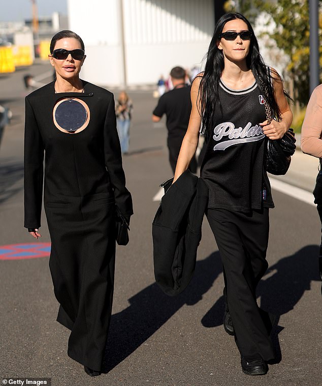 Athletic fit: The American model, 22, cut a sporty figure in a black basketball-style mesh vest that she paired with black pants