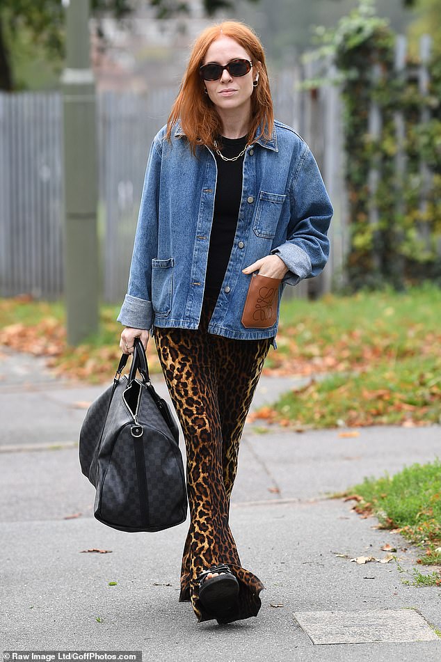 Designer's taste: the presenter looked casual with a denim jacket, flared leopard print and a Louis Vuitton bag