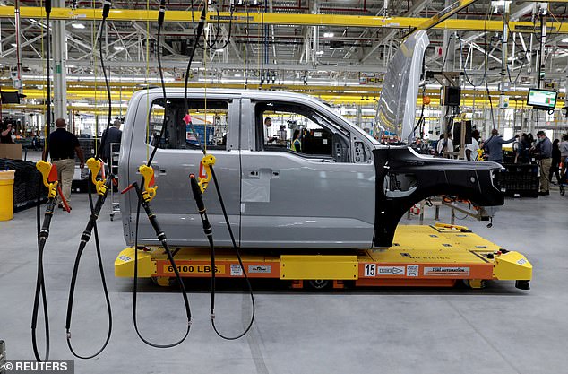 While nothing better reflects Biden's true disdain for these workers than his Environmental Protection Agency proposal to mandate electric vehicles, in less than a decade they make up two-thirds of U.S. auto sales.  (Above) The prototype of the all-electric Ford F-150 Lightning truck is seen on an automated guided vehicle