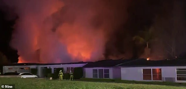 Dozens of NSW Rural Fire Service crews and about 70 firefighters were still on the ground extinguishing the remnants of the blaze (pictured) around midnight