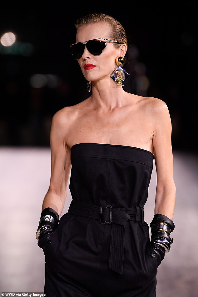 Looking good: Eva wore black gloves as she walked with the runaway, and wore chunky bracelets to give them an edgy touch