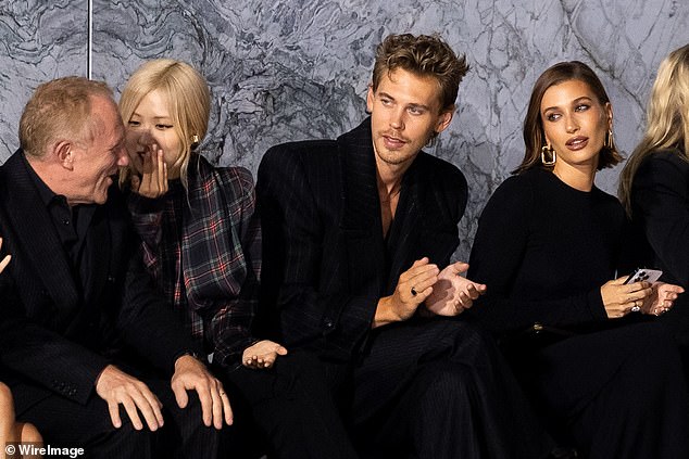 Star-studded: Austin Butler showed off his physique in a plunging pinstripe waistcoat and matching blazer as he sat alongside Francois-Henri Pinault, Rosé and Hailey Bieber