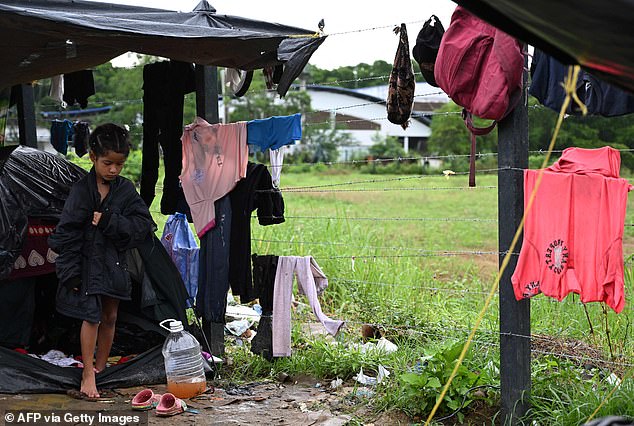 A Venezuelan migrant child stays in a makeshift tent in the Colombian port city of Turbo, near the Darien Gap