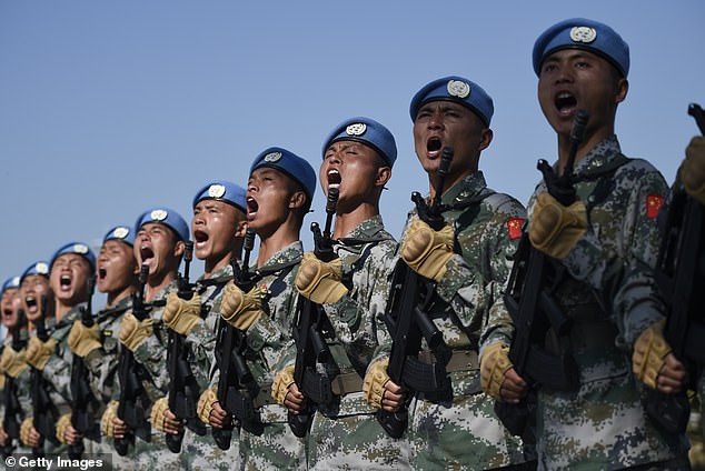 The photo shows Chinese troops taking part in marching exercises on the outskirts of Beijing.  Some experts fear that China could invade Taiwan and that Australia would be dragged into the resulting war