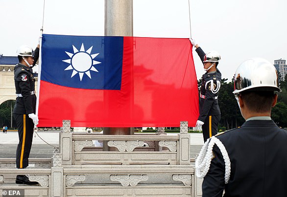 Taiwanese soldiers raise the Taiwan flag in Taipei on May 10.  China considers Taiwan part of its territory, but many Taiwanese want the island to become independent