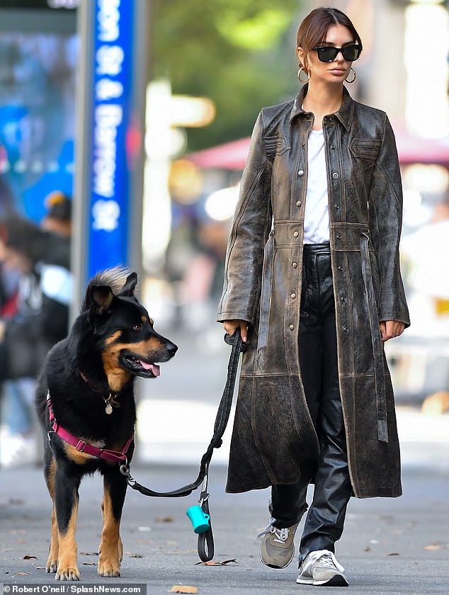 Layering: Ratajkowski wore a dark brown trench coat that fell over her toned frame and was worn over a white T-shirt