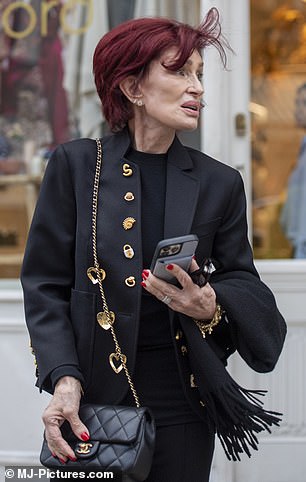 The mother-of-three looked effortlessly chic in a black blazer with gold detailing, teamed with matching trousers and heels