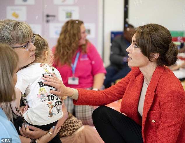 And she showed her gentle side as she rubbed a young girl's back during today's session in Kent