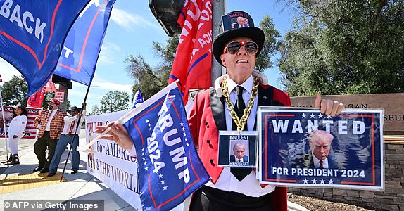 Trump supporters gather at the entrance to the Ronald Reagan Library in Simi Valley, California, on September 27, 223 ahead of the second GOP debate here, which the former president will not attend.  (Photo by Frederic J. BROWN/AFP) (Photo by FREDERIC J. BROWN/AFP via Getty Images)