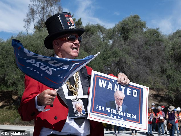 One fan made signs saying Trump, charged on 91 criminal counts, was 'innocent' and 'wanted for president 2024'