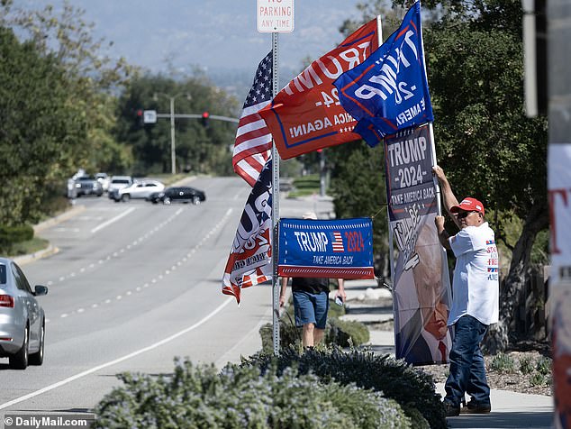 The 77-year-old's fans waved flags and banners despite him being away from California