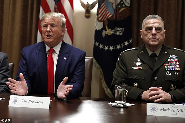 Former President Trump speaks as Chairman of the Joint Chiefs of Staff General Mark Milley (right) listens during a briefing in the White House Cabinet Room