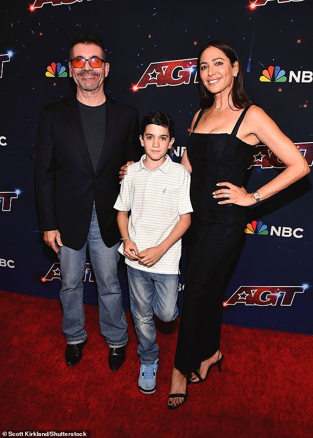 Rare appearance: Music mogul Simon, 63, and his socialite girlfriend, 46, doted on their son Eric, nine, as they posed with their arms around him on the red carpet ahead of the final