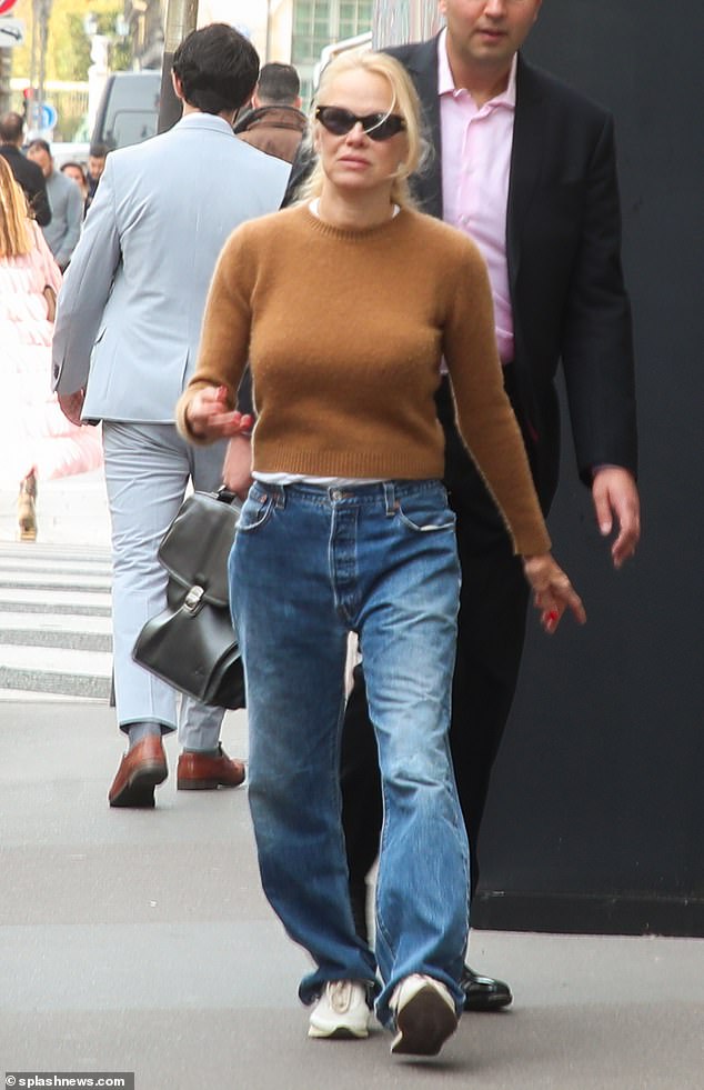 Out and about: She completed the look with a pair of comfortable white sneakers and protected her eyes from the sun with dark shades