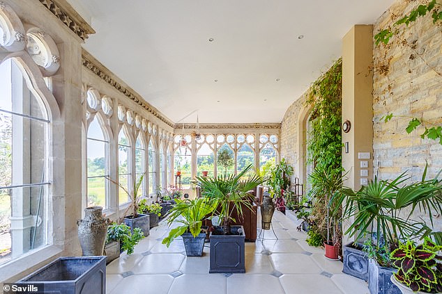 There is also an original orangery with antique arched windows and three reception rooms with fireplaces and bay windows