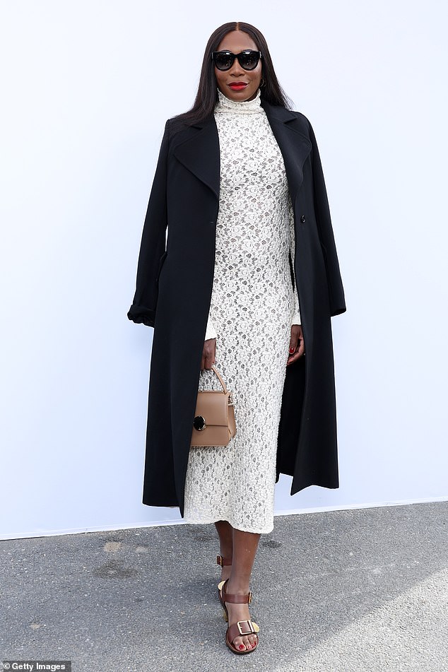 Striking: Venus Williams looked beautiful in a cream lace dress and black coat