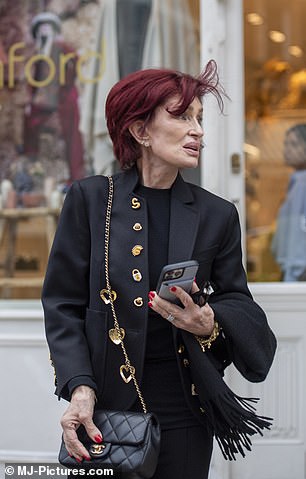 The mother-of-three looked effortlessly chic in a black blazer with gold detailing, teamed with matching trousers and heels