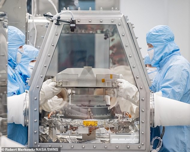 Pictured is the opening of the asteroid's OSIRIS REx sample lid at NASA's Johnson Space Center on Tuesday