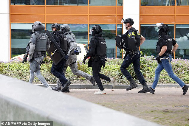 Police have launched a manhunt in the Netherlands after an attacker in military clothing opened fire