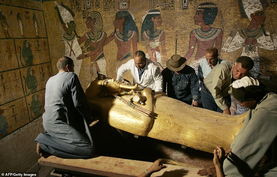 Head of Egyptian Antiquities Zahi Hawass (3rd from left) oversees the removal of the lid from King Tutankhamun's sarcophagus in his underground tomb in the famous Valley of the Kings in 2007.