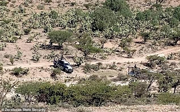 A police cruiser monitors the ranch where the bodies of six teenagers and one survivor lay on Wednesday, following their kidnapping from a ranch on Sunday morning