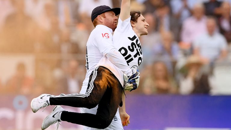 Jonny Bairstow carries a Just Stop Oil protester off the pitch at Lord's