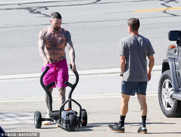 Tattoo talent: His incredible and intricate body art was on full display as he soaked up the sun during the grueling session