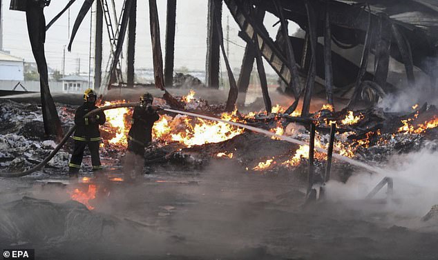 A photo provided by the government of Uzbekistan shows Uzbek firefighters extinguishing flames at the site of a warehouse explosion in Tashkent, Uzbekistan, September 28, 2023