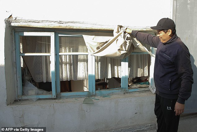 A man shows damage to his home after the explosion rocked the ex-Soviet state in the early hours