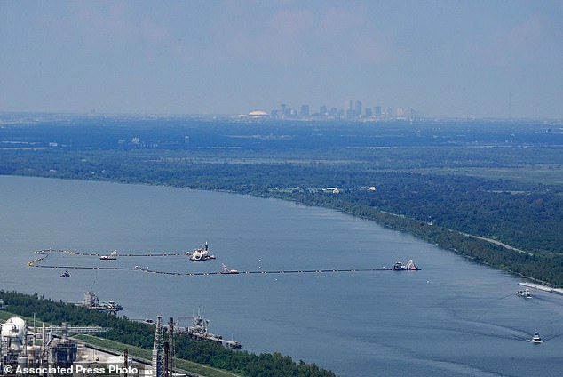 Dredging work to build an underwater sill can be seen, with the city of New Orleans in the background