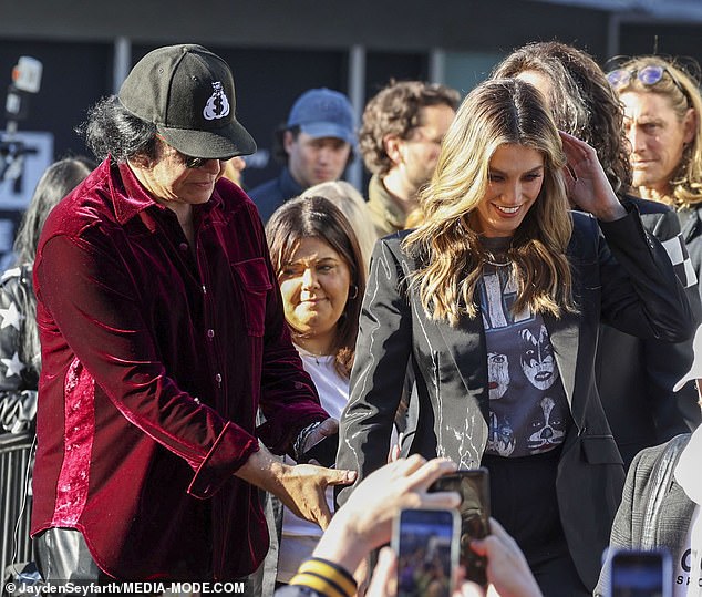 KISS bassist Gene, 74, accompanied Delta through a packed crowd of ga-ga KISS fans