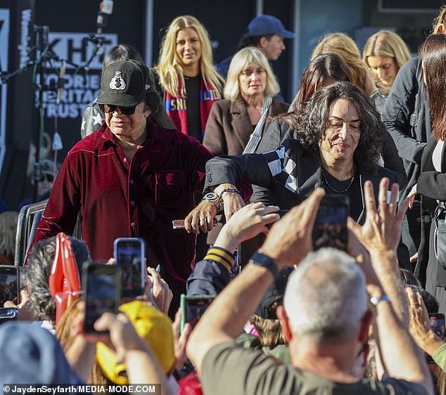 Paul, 71, (R) and his bandmate, bassist Gene (L) joined fans in the crowd