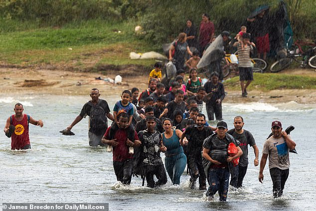 Some migrants were seen struggling with soaking wet bags of belongings as they tried to cross the river, where they were met by military troops on the Texas side.