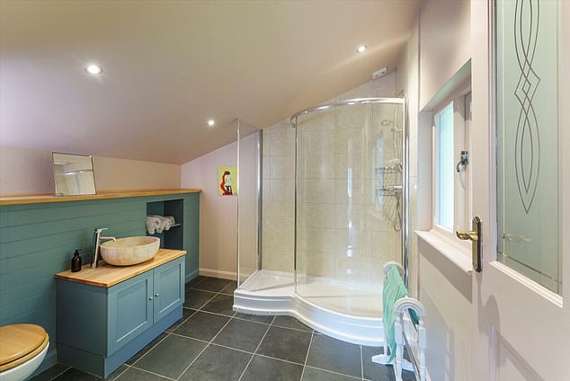 The house has three bathrooms, including this en suite with a walk-in shower on the first floor