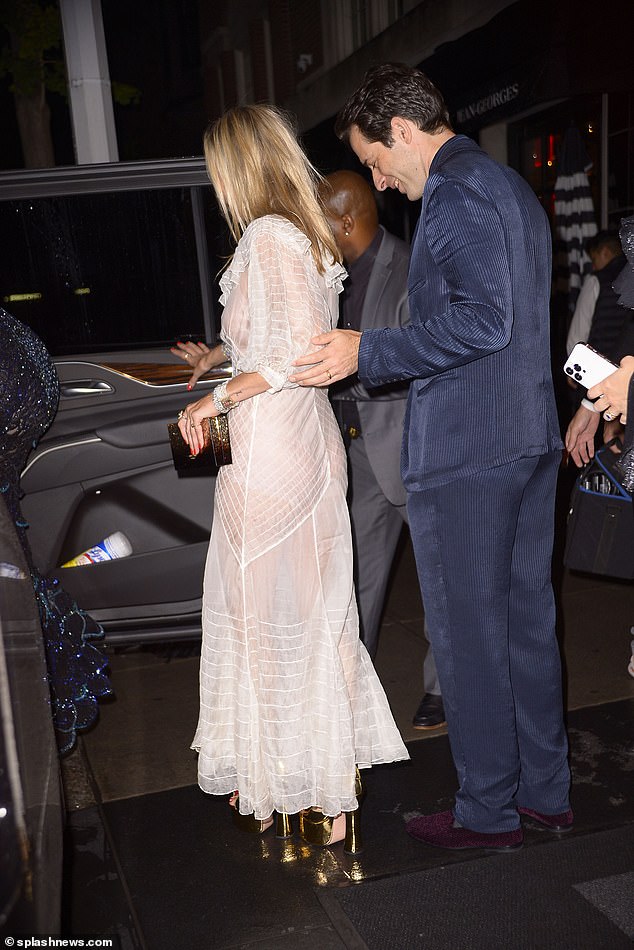 True gentleman: Ronson was dressed in a velvet, navy blue suit for the special occasion and was seen following the couple into a car