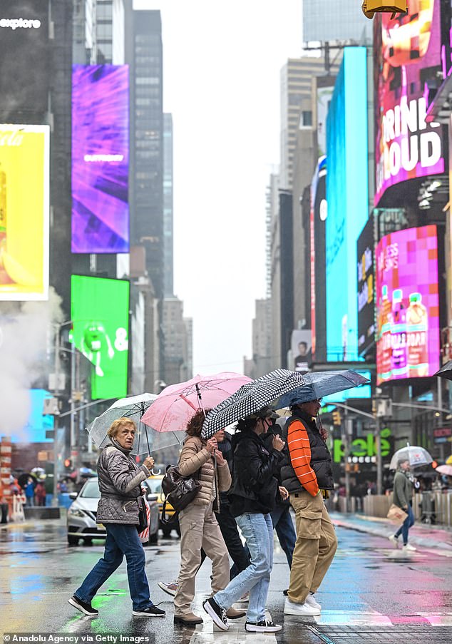 Certain parts of NYC are still saturated from last weekend's storm.  People walking through the rain in Manhattan last week (photo)