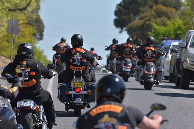 Hundreds of Bandidos cyclists ride along a main road into Ballarat, Victoria, causing traffic delays for locals on Friday