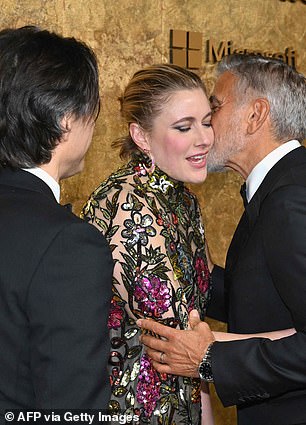 Kind regards: George planted a kiss on Greta when they met