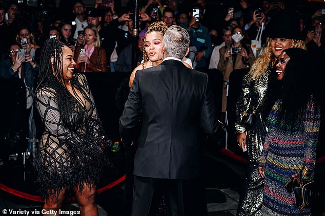 Kiss Kiss!  George Clooney kisses Andra as she came out for the glamorous showbiz evening