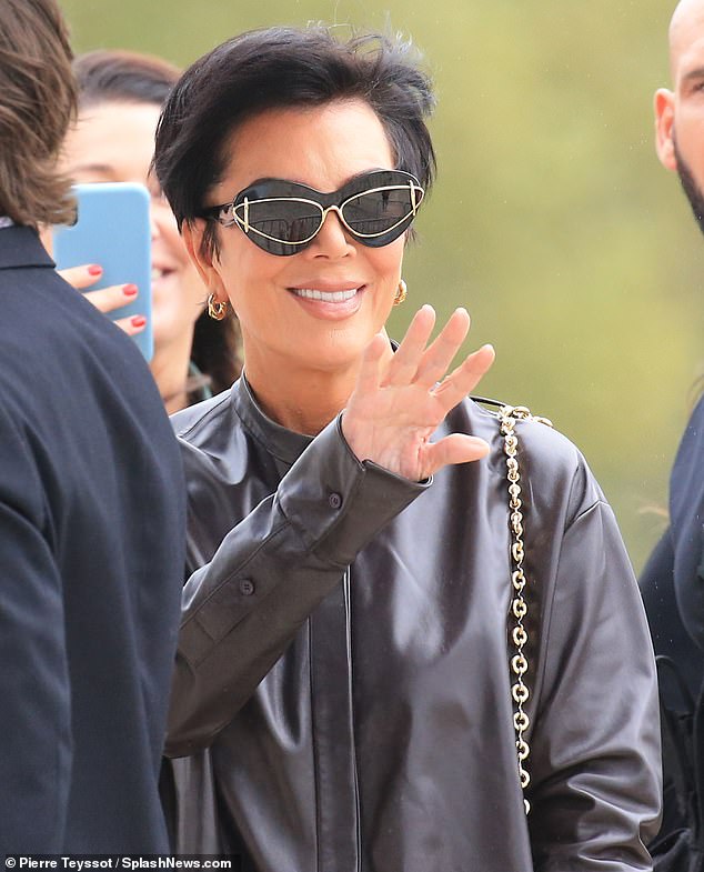 Loving life: Kris wore statement sunglasses and a leather jacket