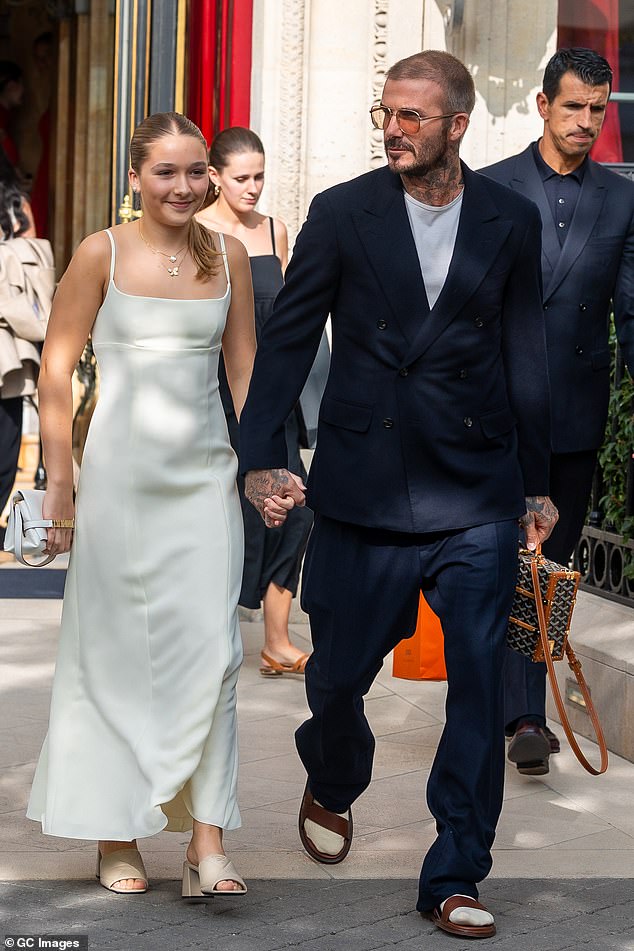 Hold Me Close: The group is in Paris to attend Victoria's third ever PFW show and ahead of the catwalk, the father-daughter duo were spotted leaving their hotel in statement looks - with David rocking socks and sandals and Harper in heels