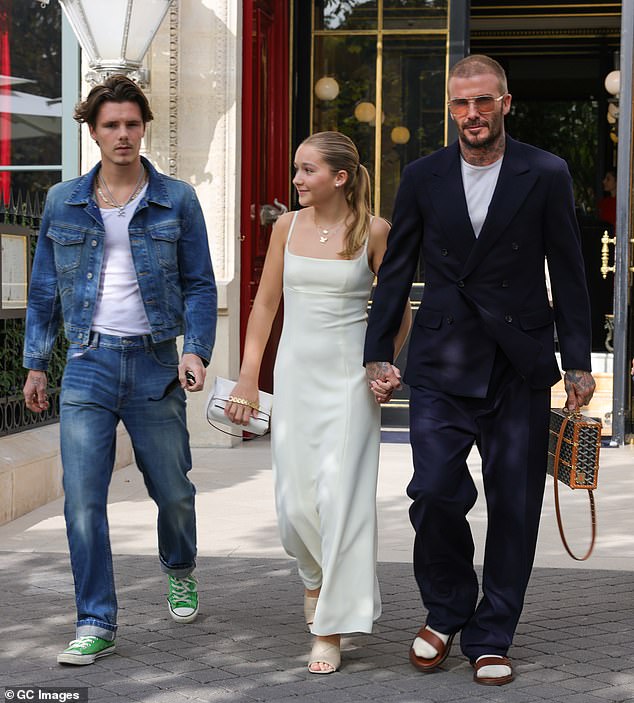 Footballs and sandals!  it doesn't look like Victoria had much of a say in her husband's outfit, while David, 48, made a rare fashion mistake in socks and sandals