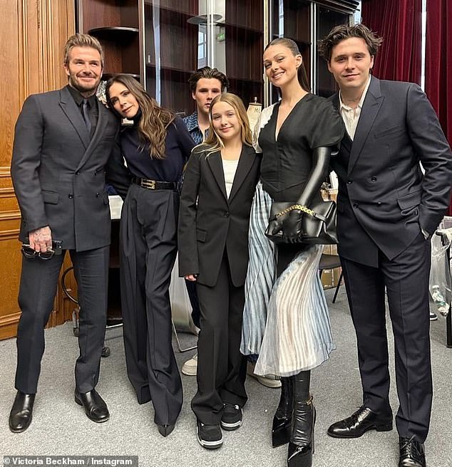 United front: The Beckham clan was out in full force for Victoria's Winter Paris Fashion Week show in March (L-R David, Victoria, Cruz, Harper, Nicola Peltz, Brooklyn)