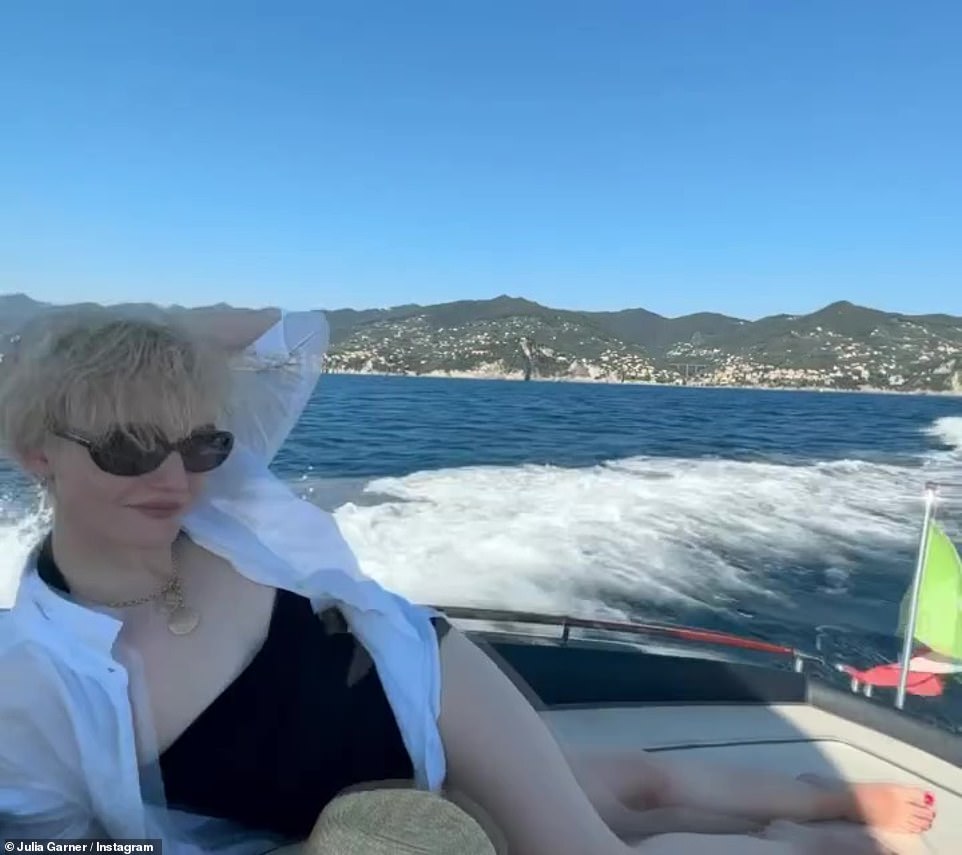 In a black suit: Garner wore a black swimsuit with black sunglasses and a white shirt