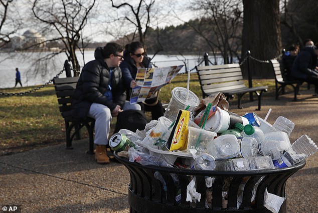 Trash cans overflow as people outside the Martin Luther King Jr.  Memorial at the Tidal Basin sitting, December 27, 2018, in Washington, during a partial government shutdown