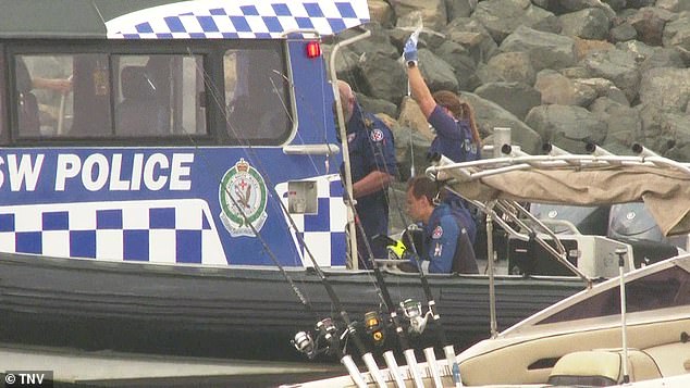 Officers pulled two men from the water in Botany Bay, south-east Sydney, early Saturday morning (photo, emergency services on scene)