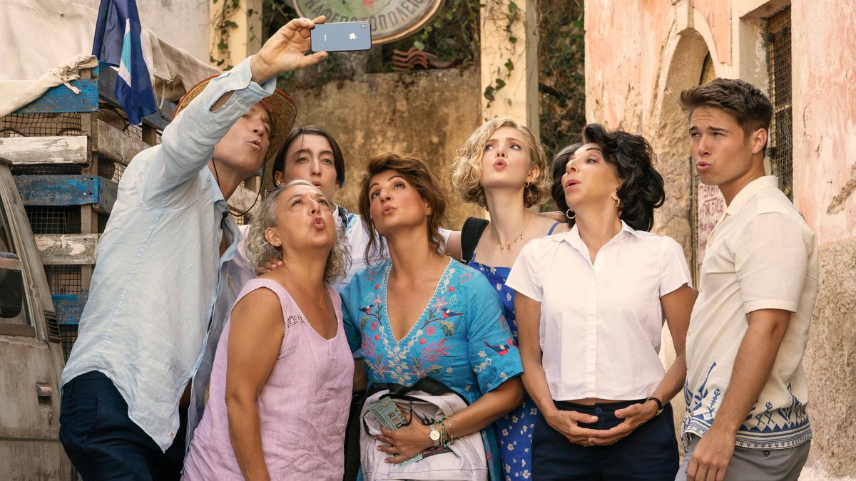 (L to R) John Corbett, Maria Vacratsis, Melina Kotselou, Nia Vardalos, Elena Kampouris, Andrea Martin and Elias Kacavas posing for a photo in My Big Fat Greek Wedding 3.