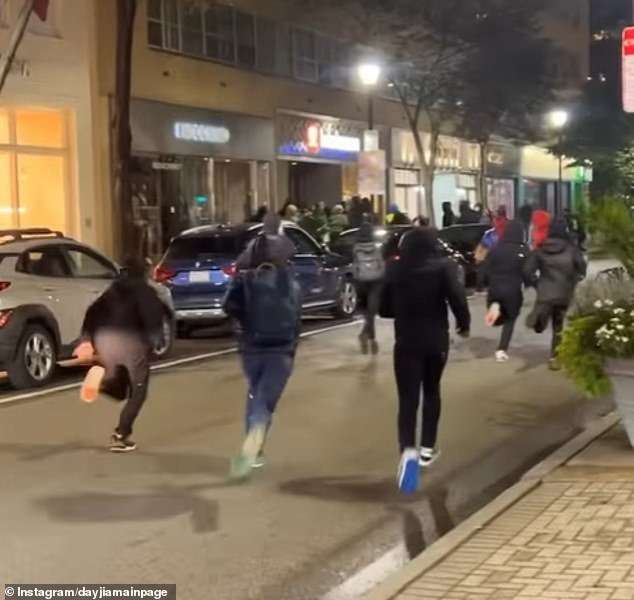 This photo shows a large number of people running toward the Lululemon store during the attack